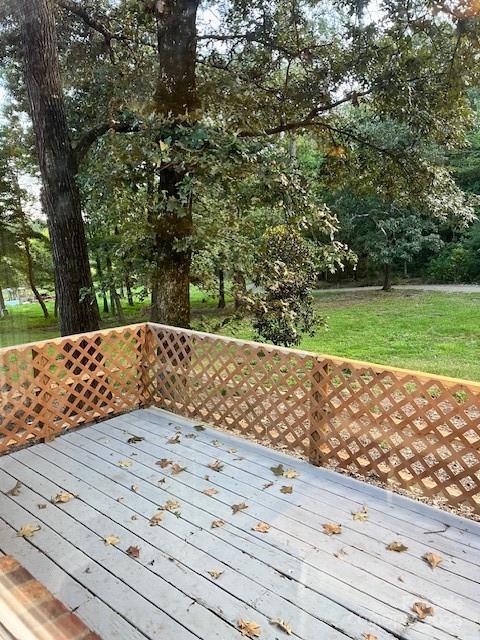 wooden terrace with a lawn