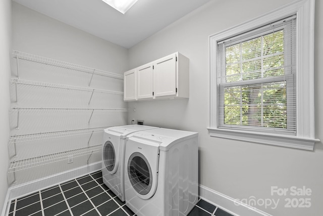 laundry room featuring cabinets and separate washer and dryer