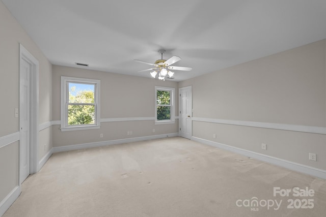 empty room featuring light carpet and ceiling fan