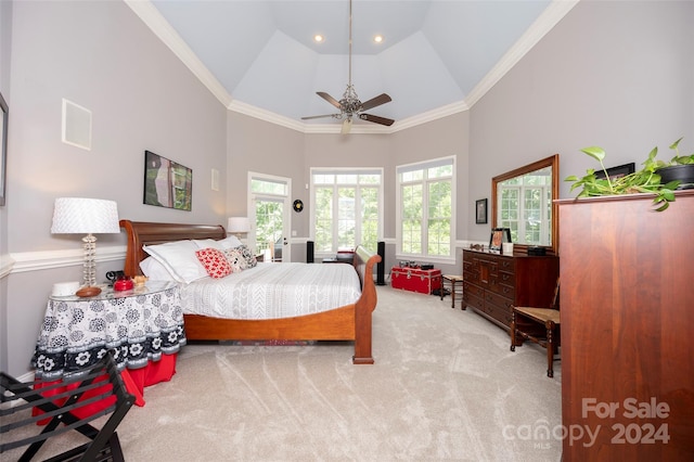 bedroom with ornamental molding, light colored carpet, ceiling fan, and high vaulted ceiling