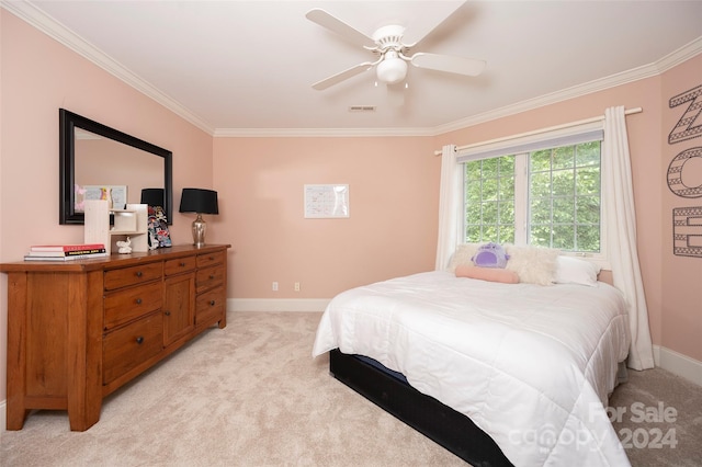 carpeted bedroom with ceiling fan and ornamental molding