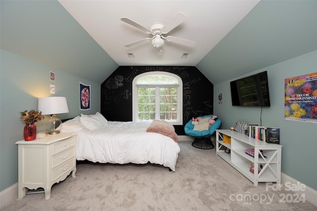 carpeted bedroom featuring ceiling fan and vaulted ceiling