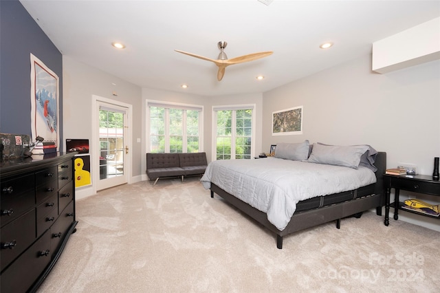 bedroom with light colored carpet, access to exterior, and ceiling fan