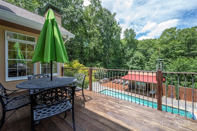 deck featuring a fenced in pool