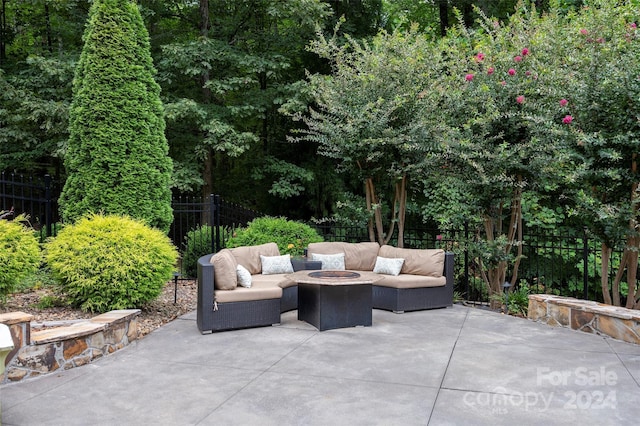 view of patio featuring an outdoor living space with a fire pit