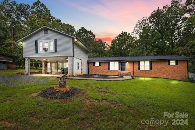 view of front facade featuring a yard and a patio