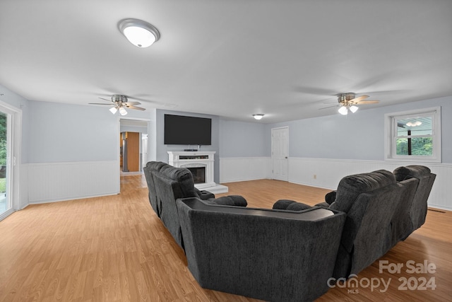 living room featuring ceiling fan and light wood-type flooring