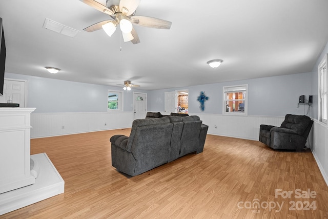 living room featuring ceiling fan and light hardwood / wood-style floors