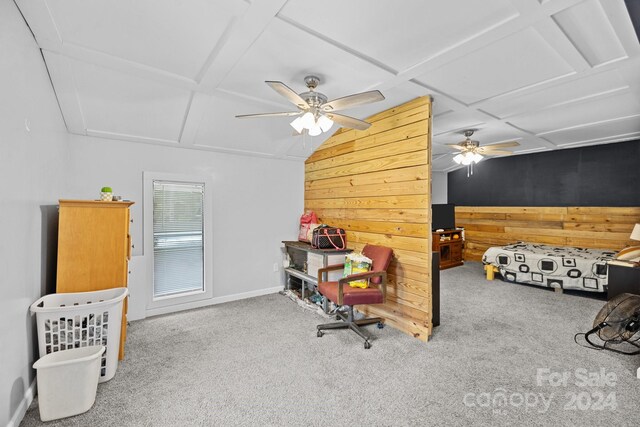 bedroom with ceiling fan, wooden walls, and carpet