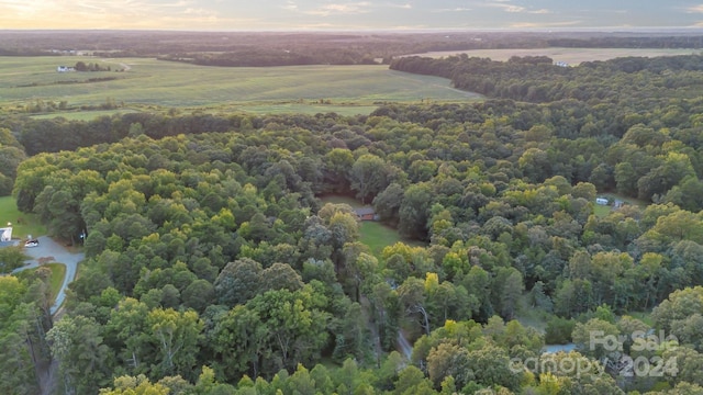 aerial view at dusk featuring a water view