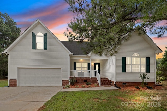 view of front facade featuring a yard, a porch, and a garage