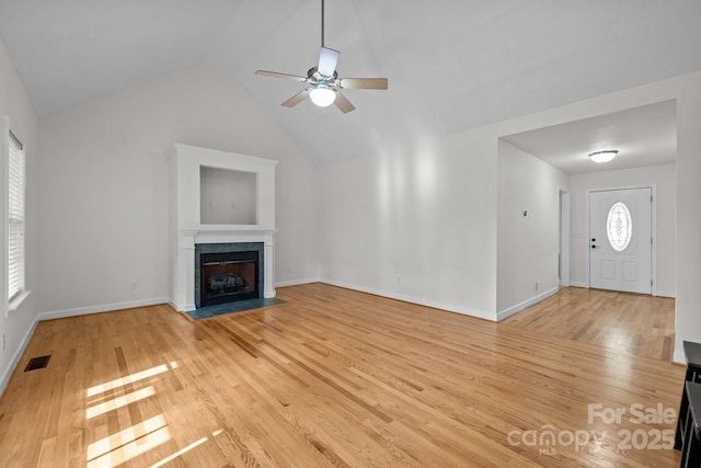 unfurnished living room featuring light hardwood / wood-style flooring, ceiling fan, and lofted ceiling