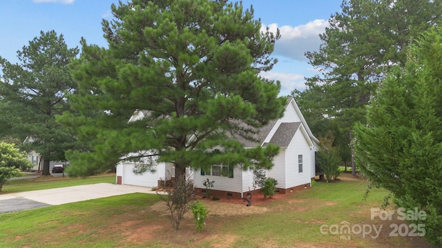 view of front of property with a garage and a front lawn