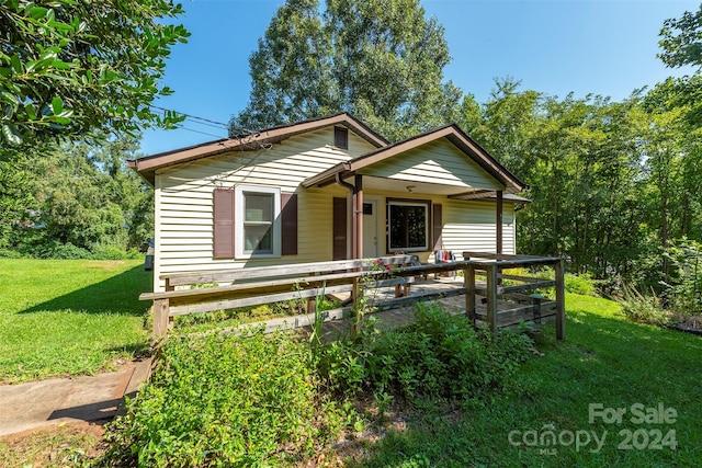 bungalow featuring a porch and a front yard