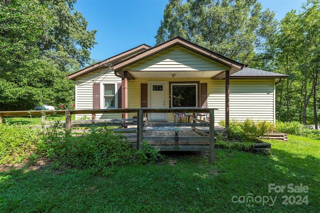 bungalow-style home with a front yard