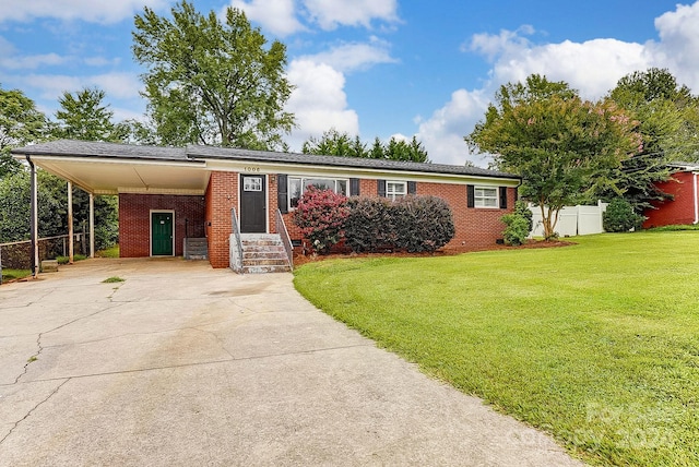 view of front of property with a carport and a front lawn