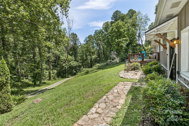 view of yard featuring a wooden deck