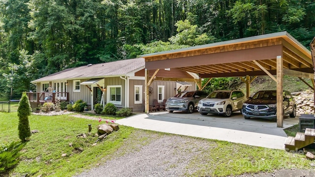 view of vehicle parking with a carport and a lawn