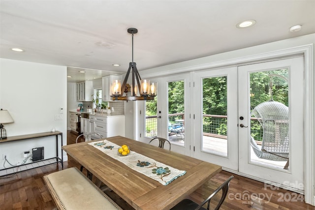 dining area with french doors, dark hardwood / wood-style flooring, and a chandelier