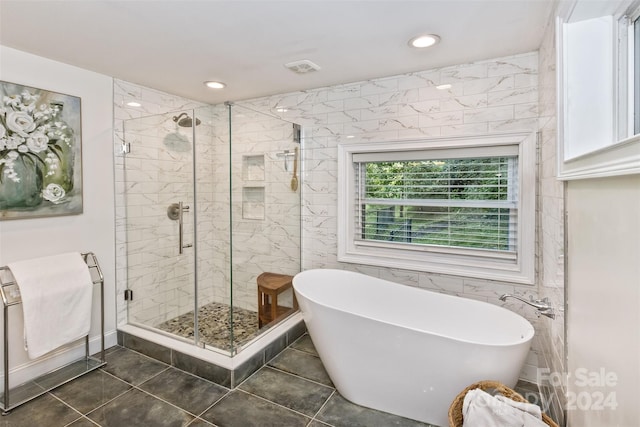 bathroom featuring tile walls, tile patterned flooring, and independent shower and bath