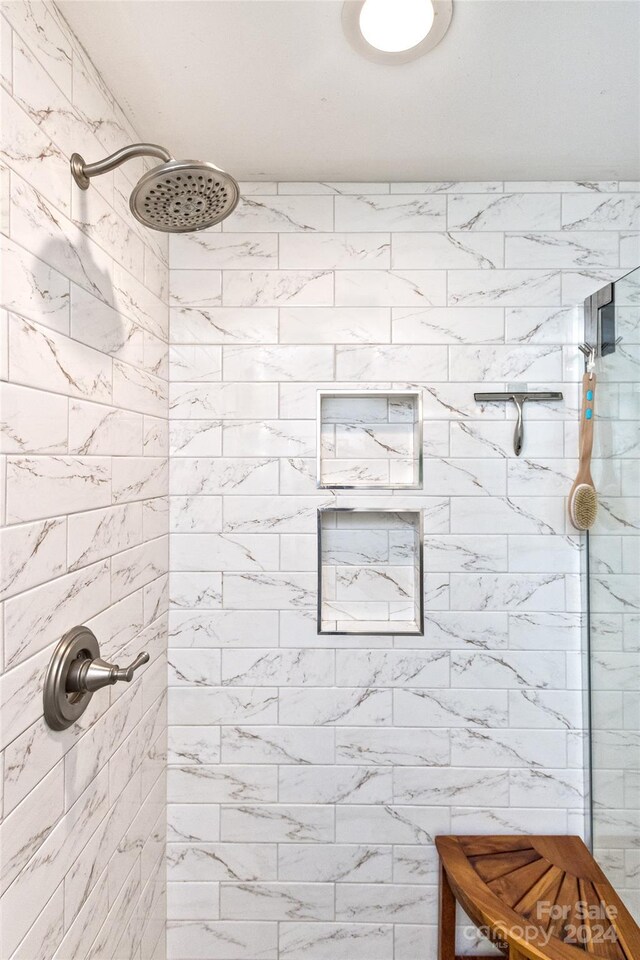 bathroom with a tile shower