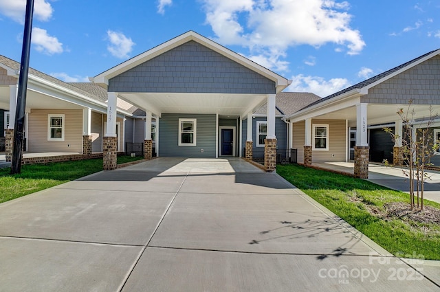 craftsman-style house with a front yard and a carport