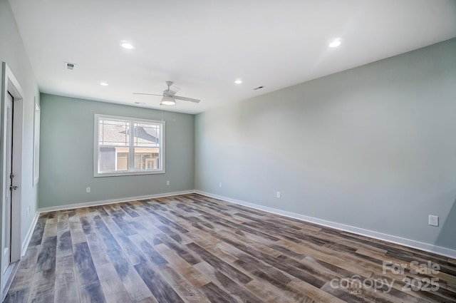 empty room with hardwood / wood-style floors and ceiling fan