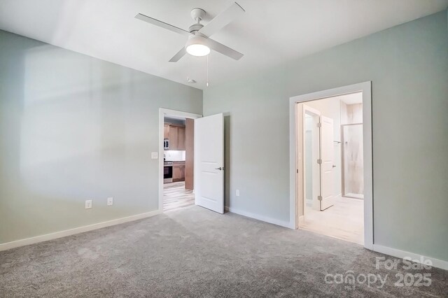 unfurnished bedroom with ceiling fan, light carpet, and ensuite bath