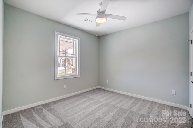 spare room featuring ceiling fan and light carpet