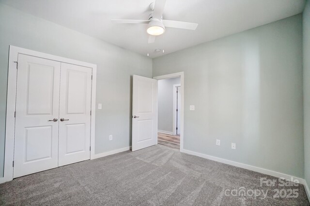 unfurnished bedroom with carpet floors, a closet, and ceiling fan