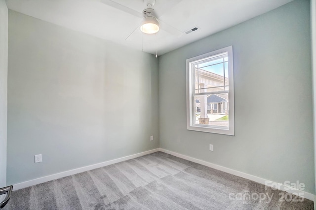 spare room featuring ceiling fan and light colored carpet