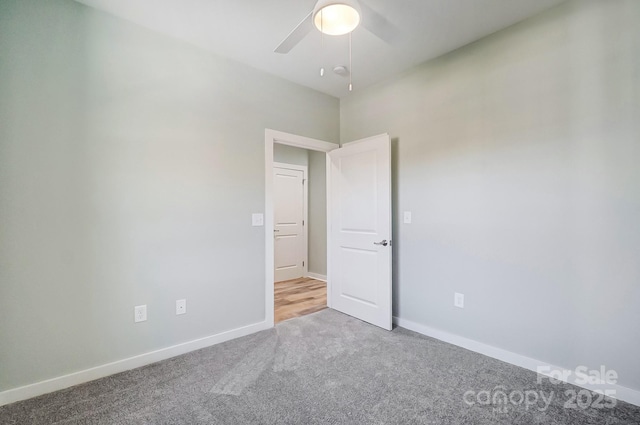 spare room featuring ceiling fan and light carpet