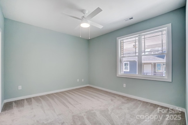 unfurnished room with ceiling fan and light colored carpet