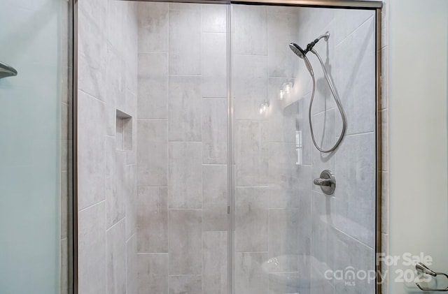 bathroom featuring a shower with shower door