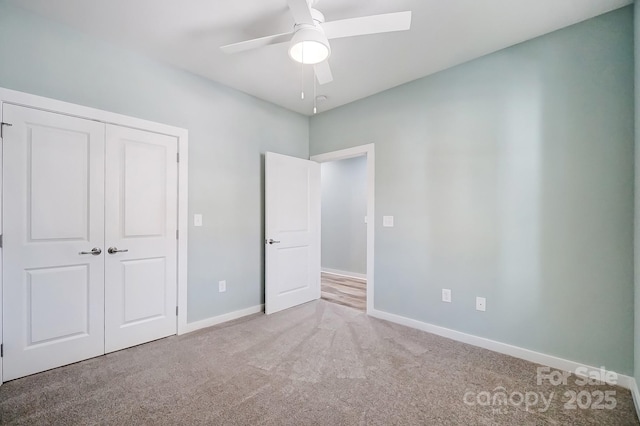 unfurnished bedroom featuring a closet, ceiling fan, and carpet floors