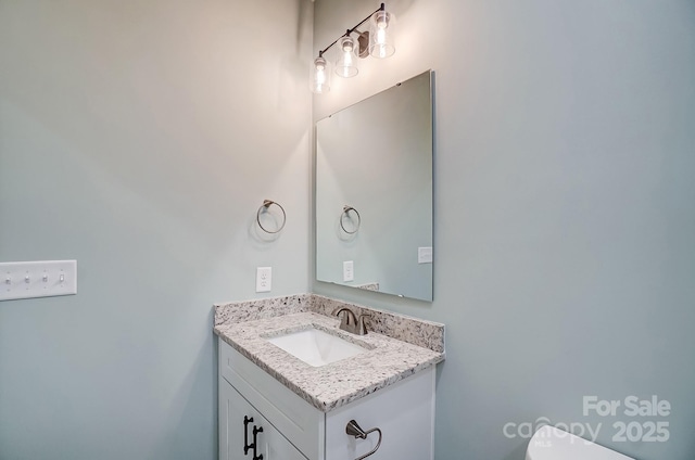 bathroom featuring toilet and vanity