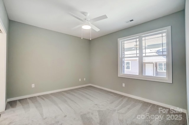 carpeted empty room with ceiling fan