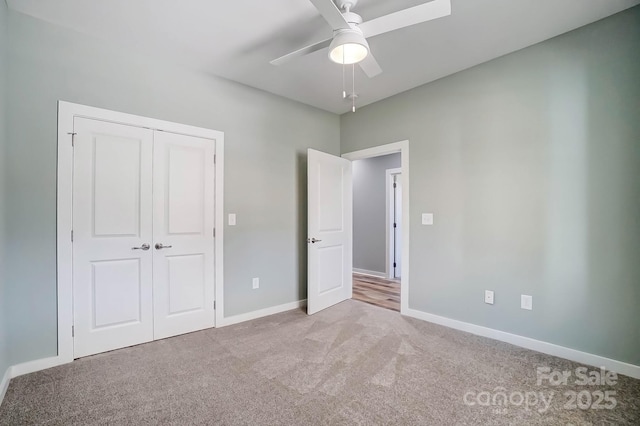 unfurnished bedroom with light colored carpet, a closet, and ceiling fan