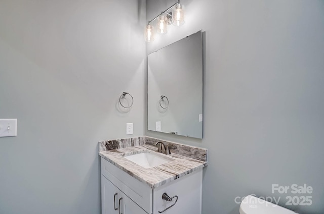 bathroom featuring toilet and vanity