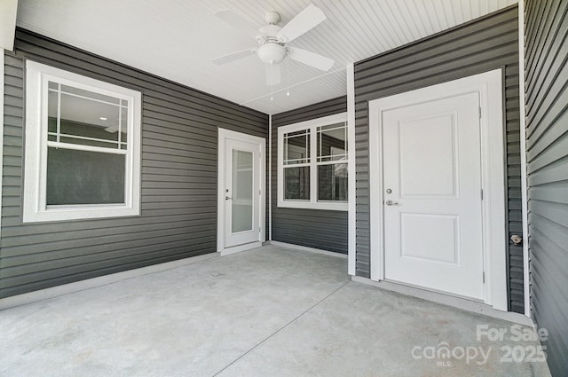 view of exterior entry with ceiling fan