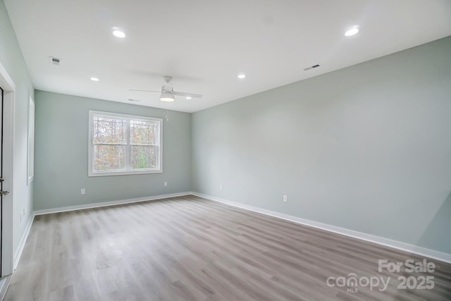 empty room featuring ceiling fan and light wood-type flooring