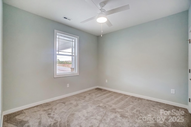 carpeted spare room featuring ceiling fan