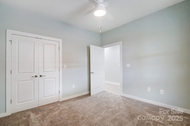 unfurnished bedroom featuring carpet, a closet, and ceiling fan