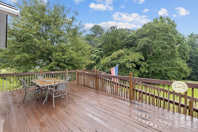 wooden terrace featuring outdoor dining space