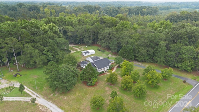 drone / aerial view with a wooded view