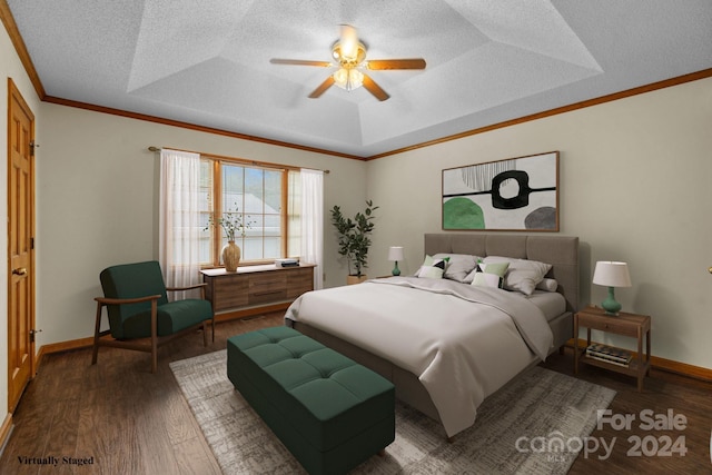 bedroom featuring crown molding, a textured ceiling, a raised ceiling, and dark wood-style flooring