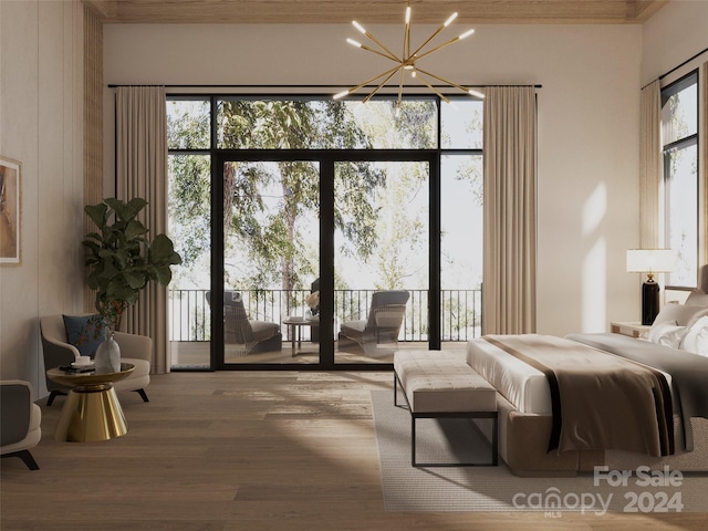 bedroom featuring access to exterior, wood-type flooring, and a notable chandelier