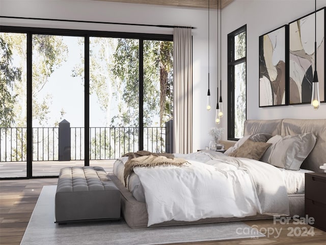 bedroom featuring access to exterior, multiple windows, and hardwood / wood-style floors