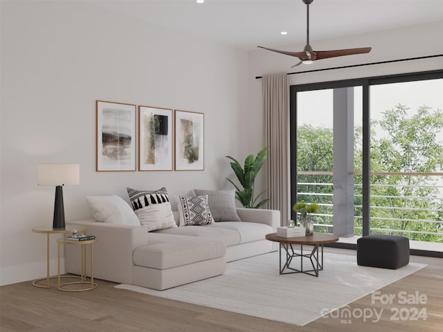 living room featuring light hardwood / wood-style floors, a wealth of natural light, and ceiling fan