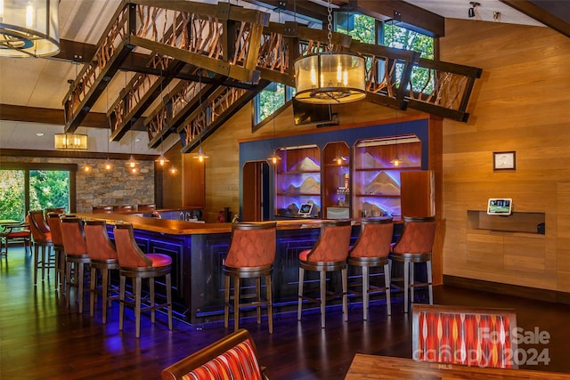 bar featuring dark hardwood / wood-style flooring, vaulted ceiling with beams, and wooden walls